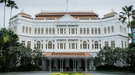 A shot of a white, grand hotel in Singapore