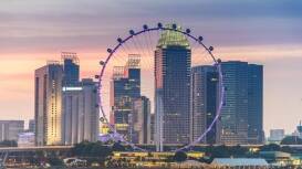 A shot of a very large ferris wheel called The Singapore Flyer, taken with the skyline behind it